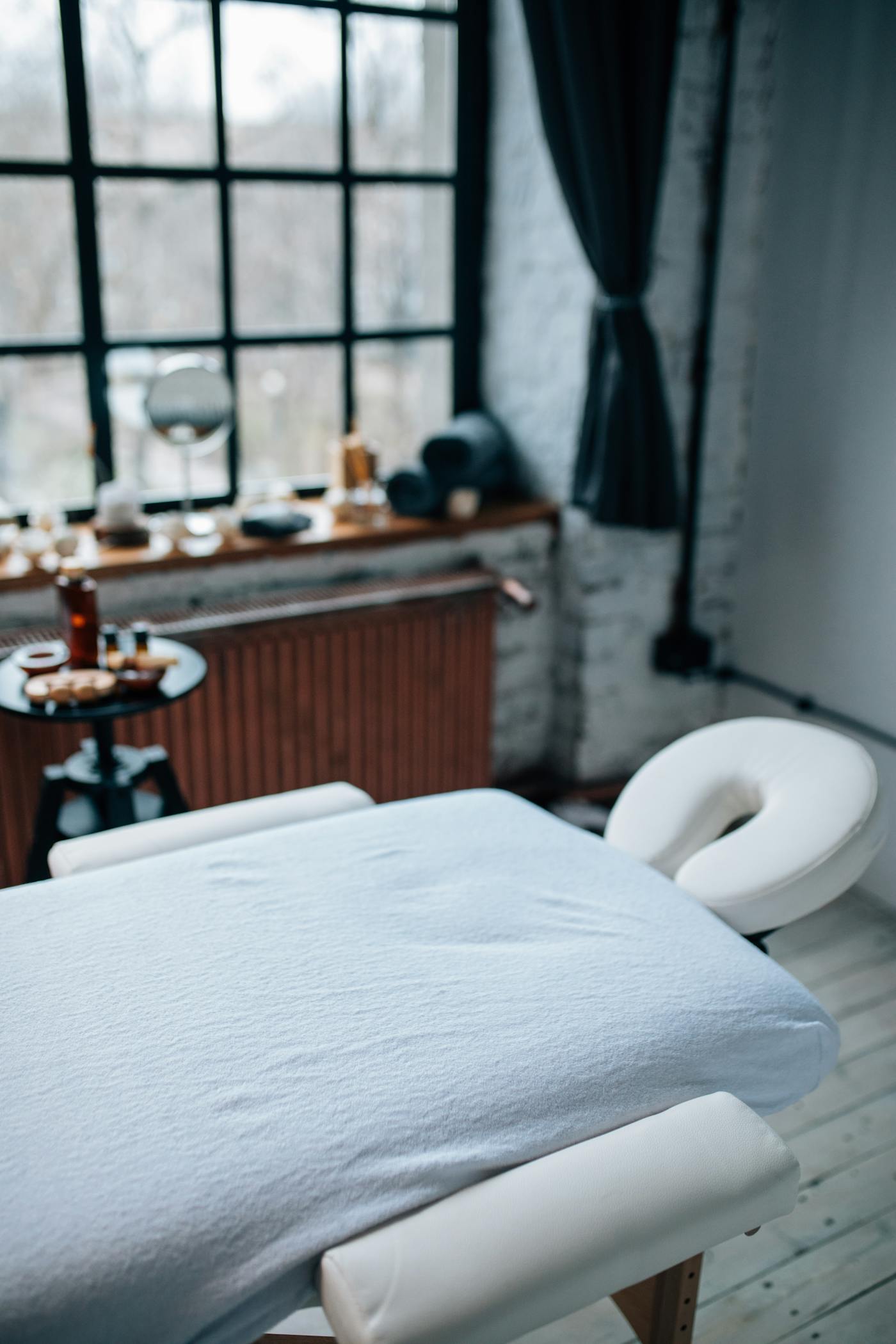 Quiet massage and bodywork room with a treatment table